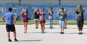 Drum major and junior Miguel Cazares leads band members as they practice for this years field show, The Adventures of Sinbad. Students hope to win the UIL State Marching Band contest.  