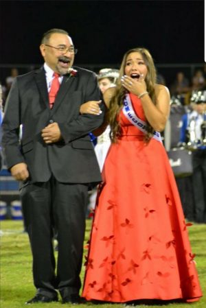 Monica Garza hears her name announced as Homecoming Queen alongside her father, Michael. 