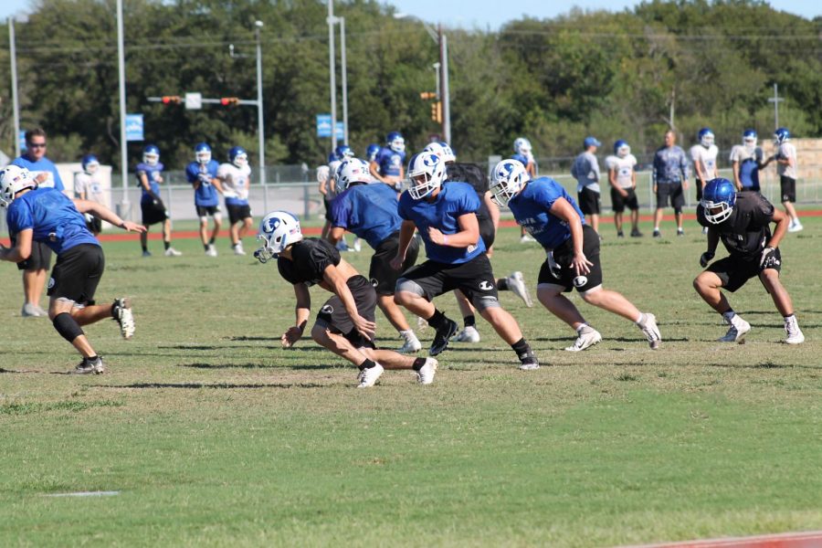 Varsity and JV football players practice after school on  Oct. 10 as they prepare for the  first district game of the year. 
