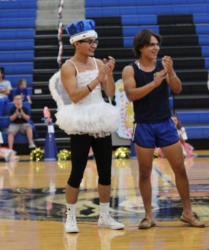 Eric Flores celebrates winning Homecoming King at the end of the pep rally. Moments before, he had performed a baton twirling routine for the talent portion of the pageant. 