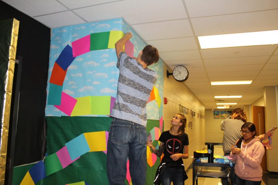 Students decorate the hall beside Kuehnes door during academic period during Homecoming week. 