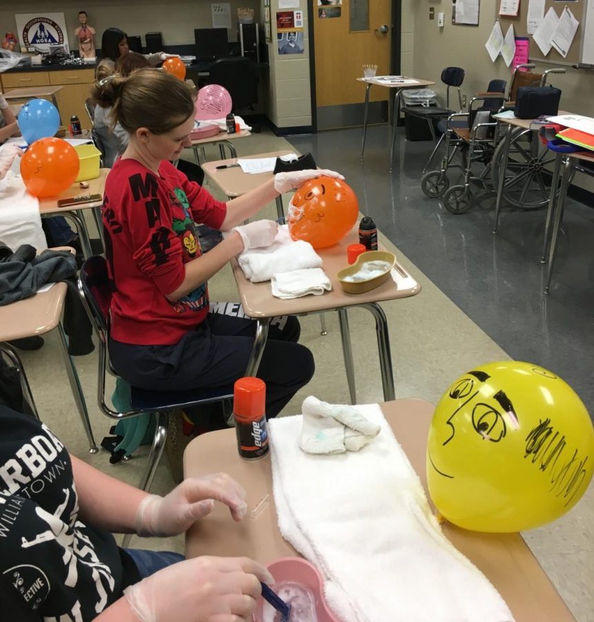 Students in Kerry Hammets CNA class practice shaving gently on balloons before visiting Spring Oaks Nursing Home to assist residents. 