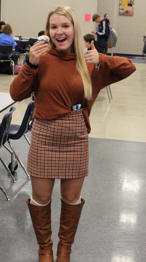 Junior Cami Ford pairing a sweater with a plaid skirt.