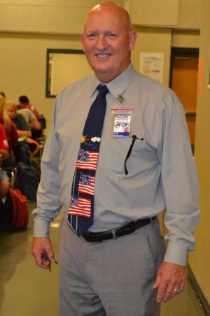Assistant Principal Joey McQueen poses in the cafeteria with his patriotic neck tie on Merica Monday.