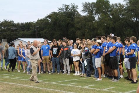 Assistant principal  Joey McQueen  speaks to seniors at Badger Stadium  during the senior ceremony pep rally on Sept. 26. 