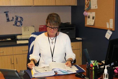 Mrs. Davis works as registrar in her new office between the library and lecture hall. She was previously the counselors secretary and became the registrar at semester. 