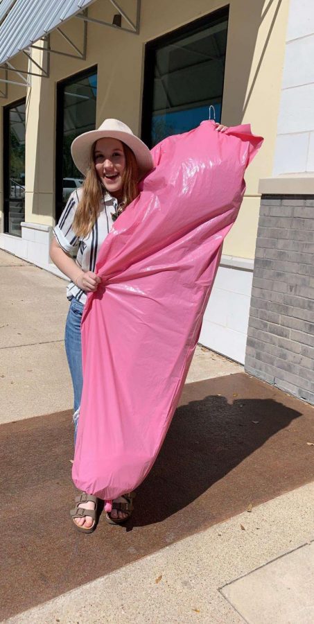 Ferguson holds her new prom dress outside of Z Couture in Austin. LHS Prom is on April 6.