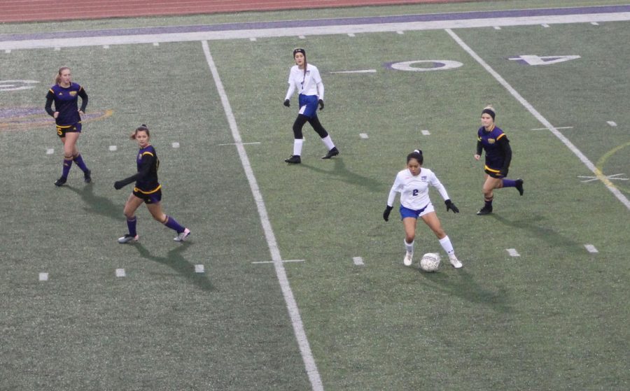 Junior Winter Mendez (2) makes a move on the ball to get past Liberty Hill defenders while sophomore Sydne Bunce (1)makes a run on Feb.  19.