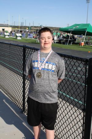 Life skills student Phillip Hallahan smiles with his medal after running   The Hundred Meter Special Race at the Burnet track meet on March 21.