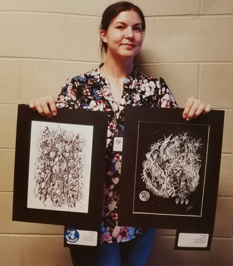 Senior Amanda Fuller stands with her two art pieces which received a four out of five ranking at the state meet April 27.