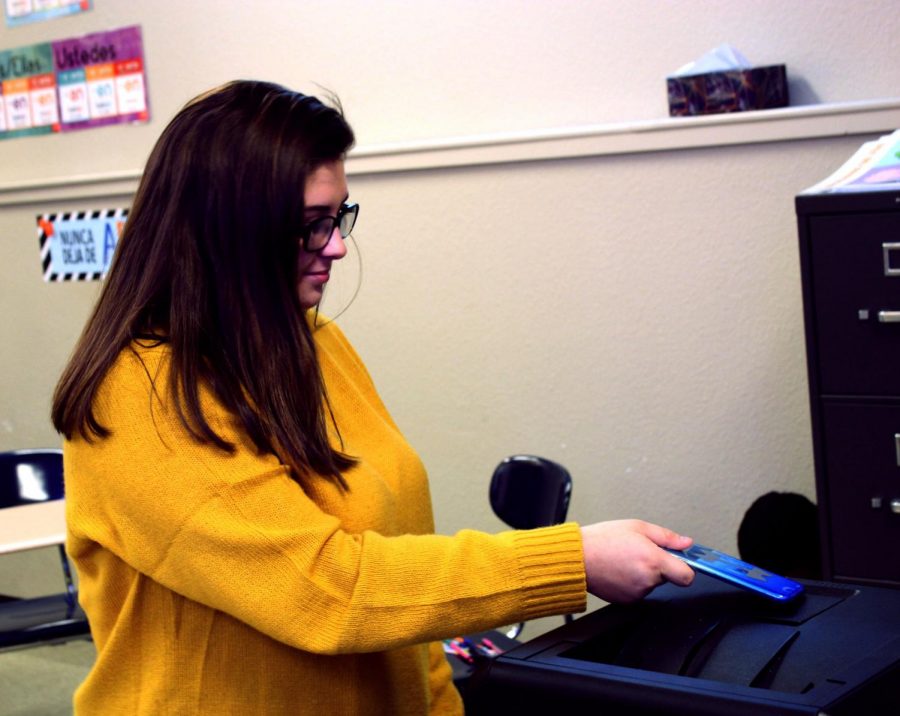 Freshman Leanna Rivera sets her phone on Spanish teacher Ms. Stednitzs printer before going to the restroom during 8th period on Aug. 30.