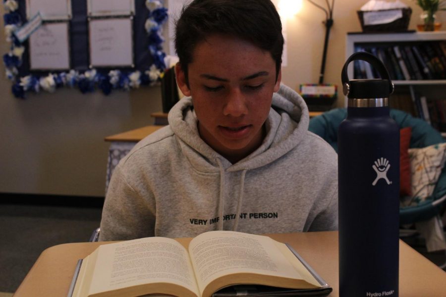 Freshman Samuel Zmolik reads with his Hydro-flask on his desk during academic period. 