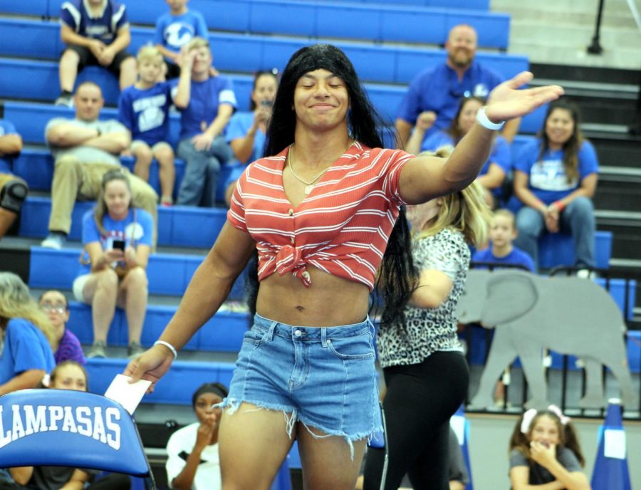 Senior Daunte Cuffie, dressed as Dauntisha Buffie, struts to answer a question from Buster Badger during the dating game on homecoming. 