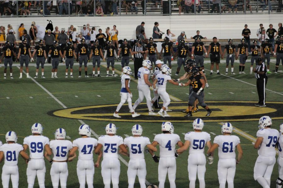 Starting varsity players Koby Allen, Jaylon Porter and  Caden Thrift go up to shake hands with Gatesville captains before the game. 