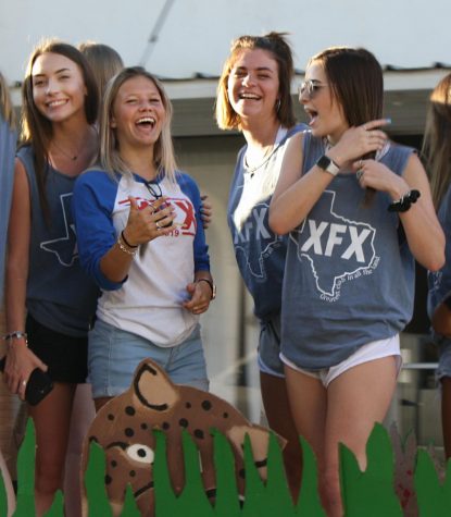 Juniors Kerbi Wiley, Amberly Adams, sophomore Rebekah Pearce and junior Brinley Klosterhoff enjoy riding on the XFX float during the homecoming parade. 