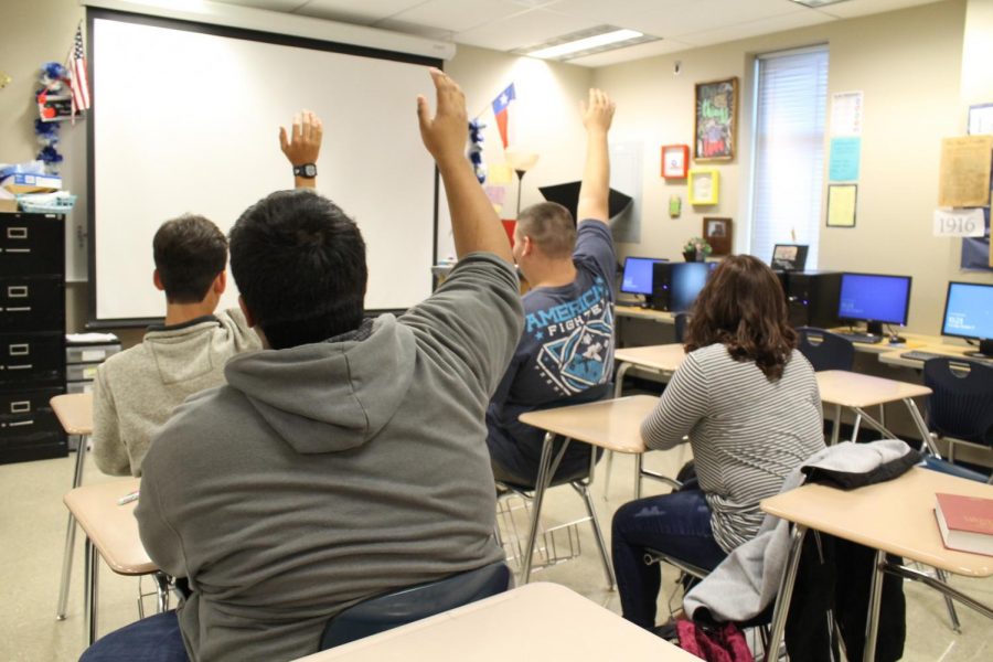 Male students sit in class and answer questions while the female sits behind them without voicing her opinion on certain topics. Studies show teachers can react differently to boys than girls, ultimately causing educational boundaries for females. The photo depicts how the public school system looks over the thoughts and opinions of females. 