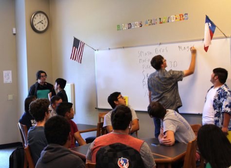 Senior Morgan Dandley listing game options on the whiteboard in the library on Sept. 25 during The Gaming Club.