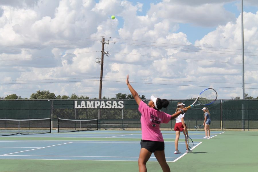 Freshman Hannah Durbin serves the ball during tennis practice.