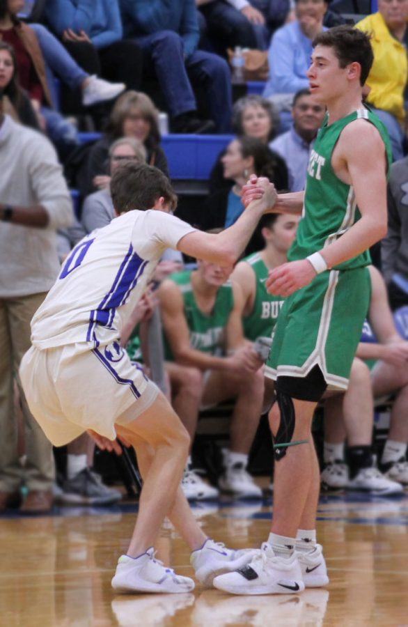 A member of the Burnet basketball team lends a hand to Lampasas player Nate Borchardt during their game Feb. 7. Lampasas beat Beat Burnet 69 -56. 