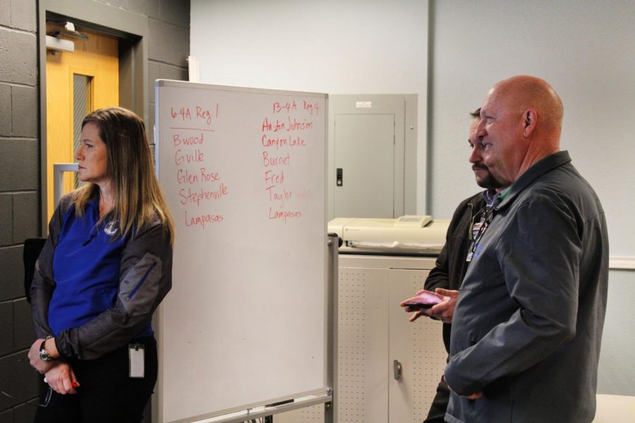 Head of athletic training Jan Brister, assistant superintendent Kevin Bott and Principal Joey McQueen study the UIL realignment projected in the Maker Space Feb. 3.