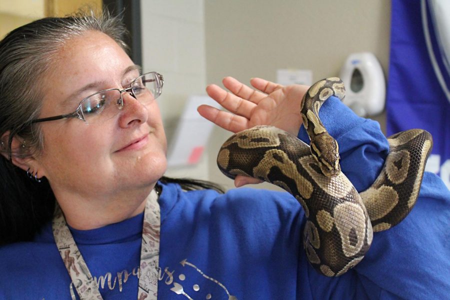 Biology teacher Dejah Bushong holds Barrie, her pet ball python.