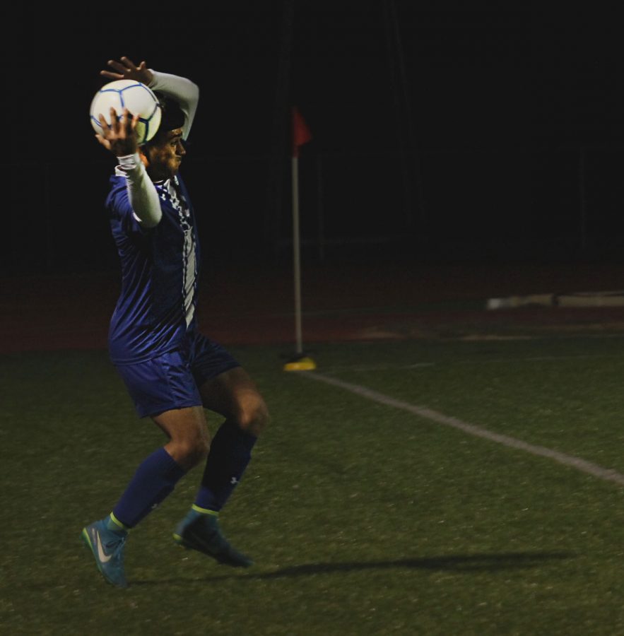 Junior Victor Castruita throws the ball into play on the field during the varsity soccer game on Jan. 28 at home. The boys took home a win of 9-0 against Florence.