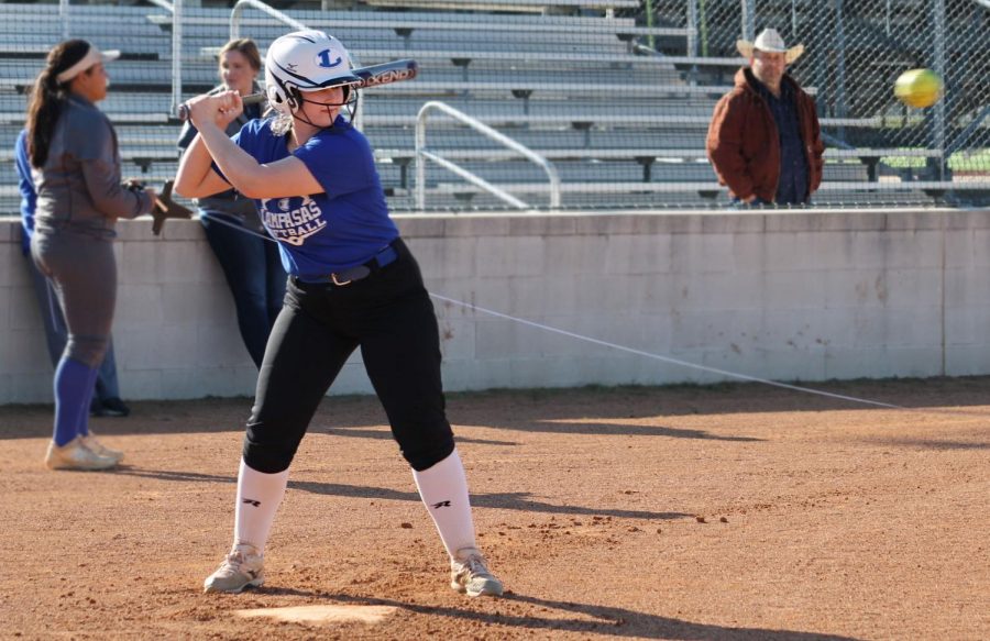 Senior Hannah Greenberg loads up as she prepares to hit the softball at practice Feb. 6.