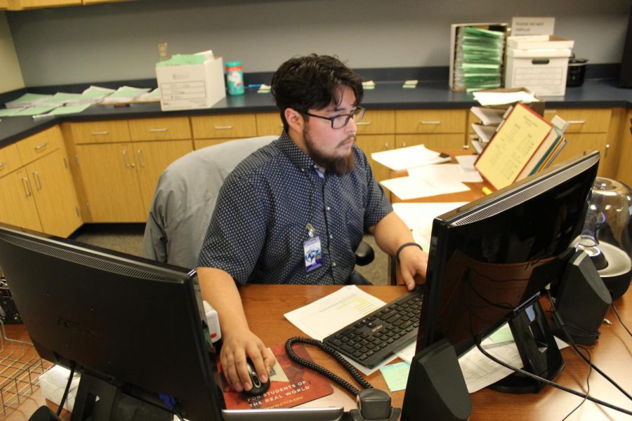 Attendance clerk Jesse Tyler Castenada works at his desk March 4.