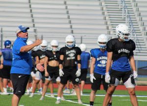 Coach David Brister talks to players on special teams lining up at after school practice Aug. 19. 