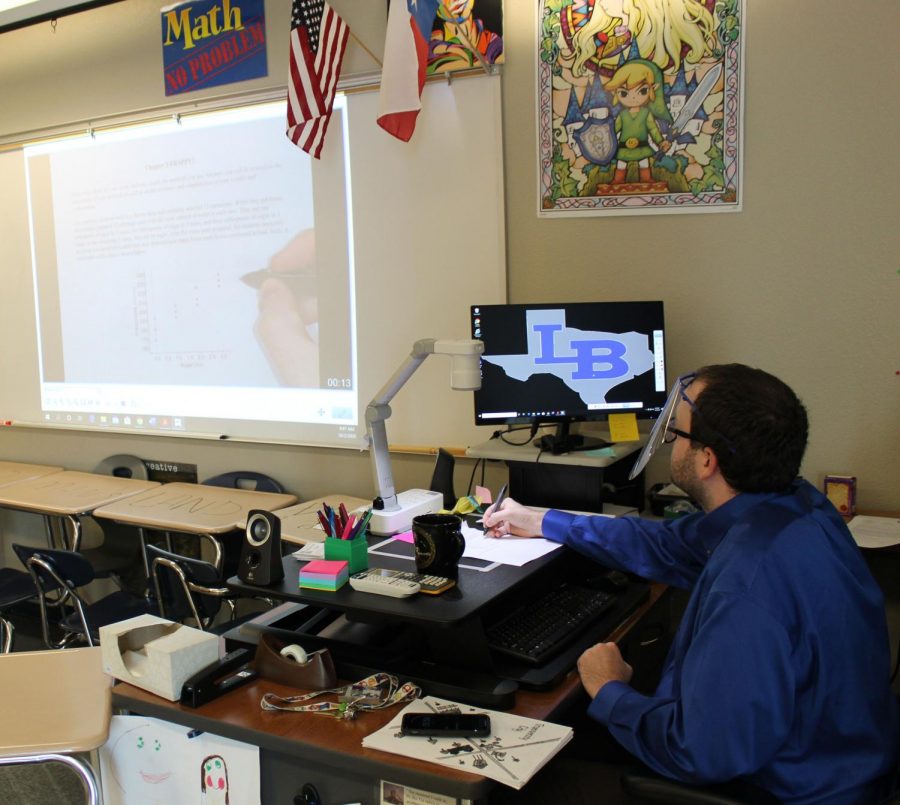 Math teacher Jesse Cox teaches AP statistics under his document camera. He often uses this method to record his lessons for virtual students. 