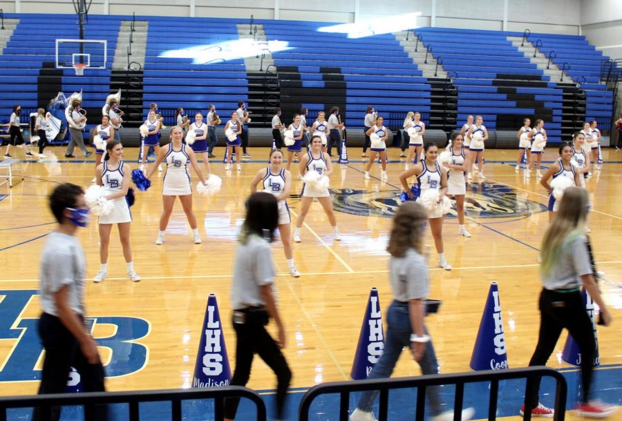 The band enters the gym with empty bleachers as the cheerleaders perform to record the first virtual pep rally Sept. 30. The pep rally will be shown tomorrow during academic period. 