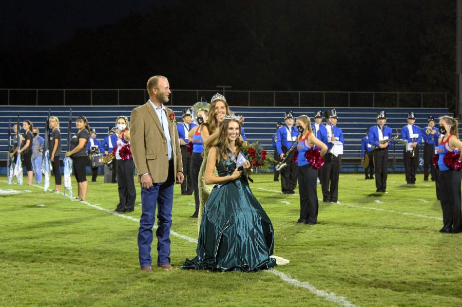 Senior Addison McDonald is crowned 2020 homecoming queen by 2019 homecoming queen Jessica Ball.