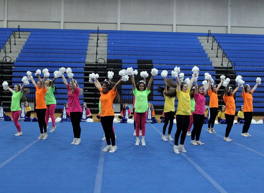 The cheerleaders perform in a triangle formation. 
