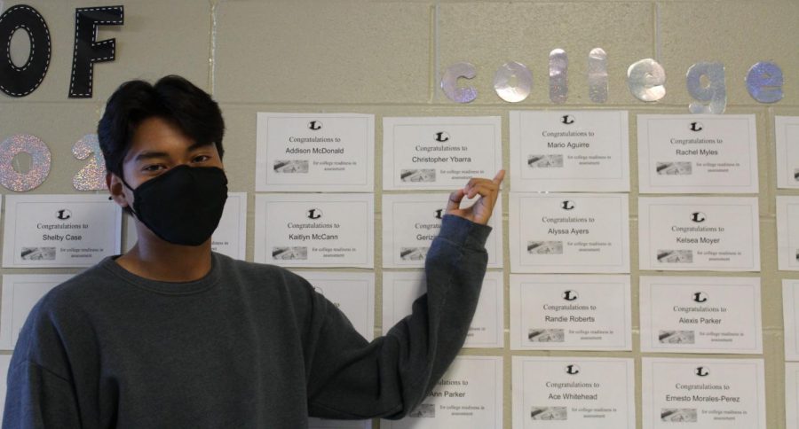 Senior Mario Aguire points to his certificate displaying his college readiness.