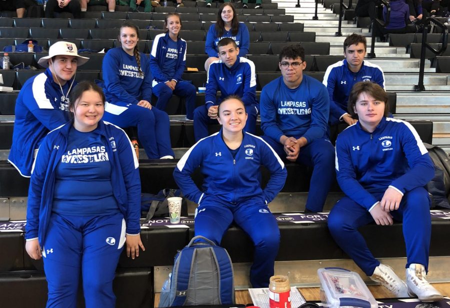 The varsity wrestling team sits together at the District meet in College Station April 9. 