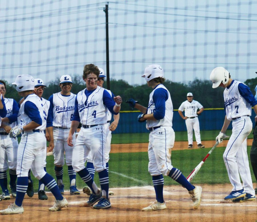 Senior Ace Whitehead fist bumps senior Guage Gholson after hitting a home run in the Badgers home victory against Brownwood April 6. 