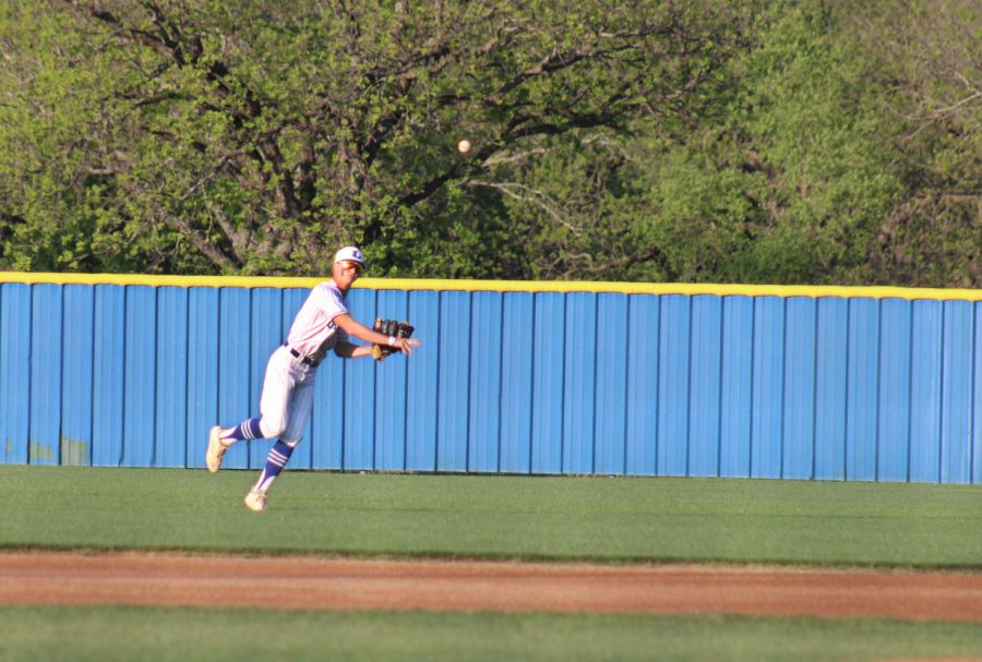 Senior Kash Corbin throws the baseball to warm up before the game April 20. 