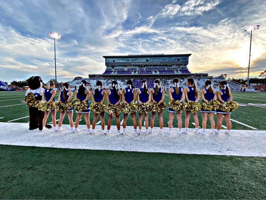 Cheerleaders stand  on the sidelines during the 2020 football season. 