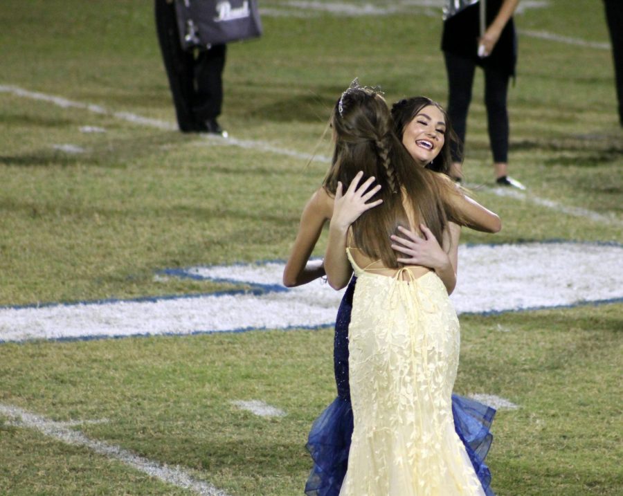 2021+homecoming+queen+Jara+Stephens+hugs+2020+homecoming+queen+Addison+McDonald+when+she+learns+she+won+during+the+football+game+Sept.+17.