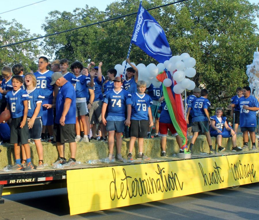 The middle school football team rides a float at the homecoming parade Sept. 15. 
