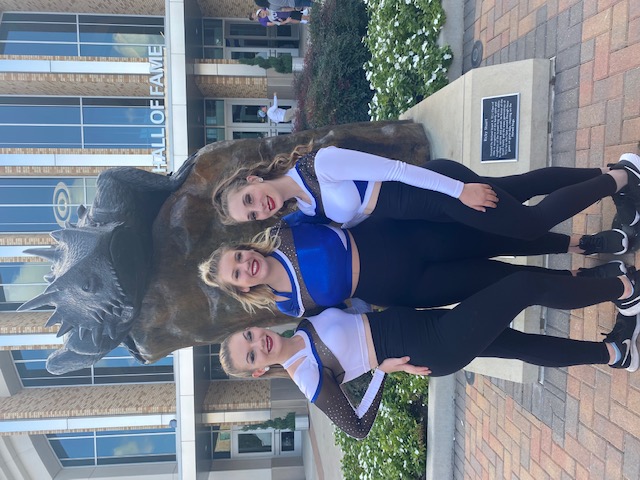Senior April Smith, sophomore Jaycee Lockhart and senior Brooklyn Morris pose in front the Hony Toad statue at the TCU campus. 