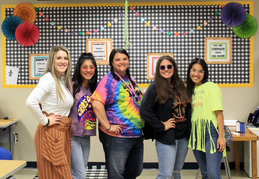 Junior Avery Bolm, sophomore Arielle Aguirre, coach Shannon Lindsey, freshman Julia Ybarra and senior Koral Amador pose for a picture dressed up as hippies to say Peace out to drugs Thursday. 