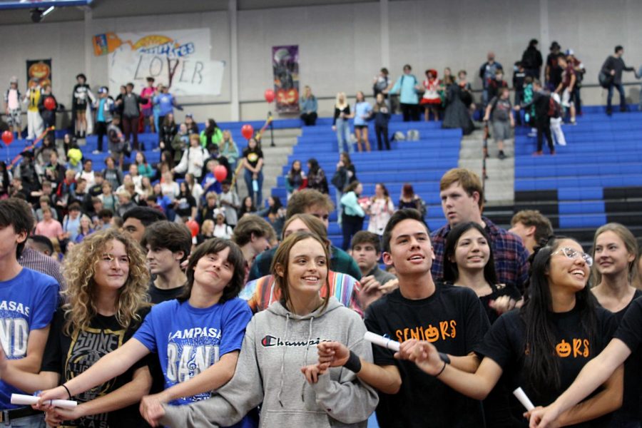 The senior class sings the school song together at their last pep rally. 