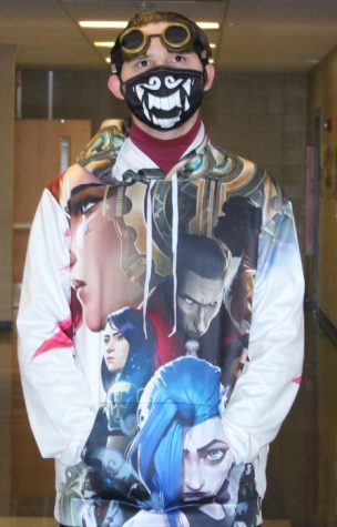 Senior Nicholas Cobb wears a hoodie with characters from the show Arcane. He also wears goggles inspired by the show. 