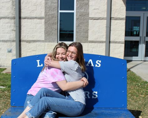 Seniors Ashleigh Reavis and Kayla McManus hug outside the high school today. 