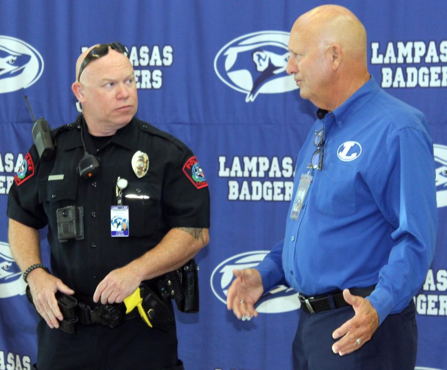 Officer Chad Curtis and Principal Joey McQueen talk at the school entrance on the morning of Aug. 17.