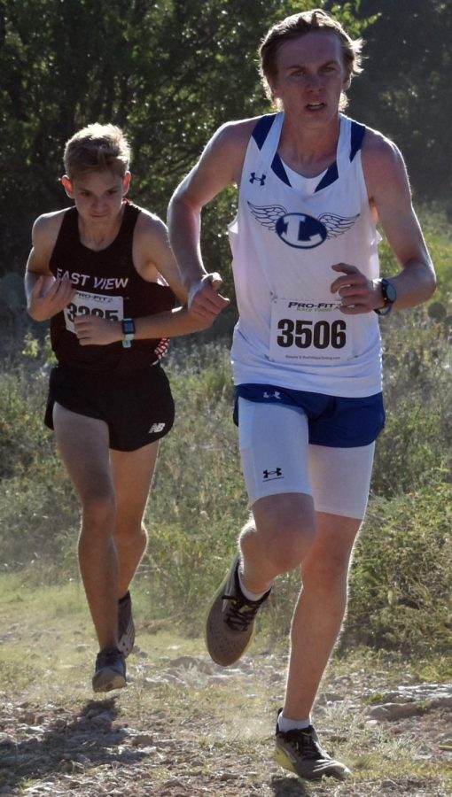 Sophomore Brayden Phillips passes another runner on the course at Lampasas Sports Complex Sept. 22.
