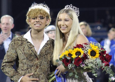 Homecoming king Seth Norton and queen Madison Roedler pose for pictures together after Roedler was crowned at the football game Sept. 23.