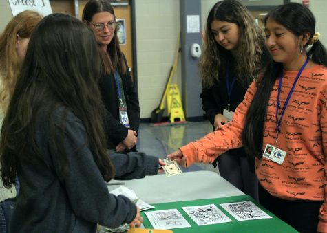 Freshman Giselle Ruperto buys a candy gram from drawing students Lydia Skiles and Sumiko Lemari  during lunch Oct. 19.