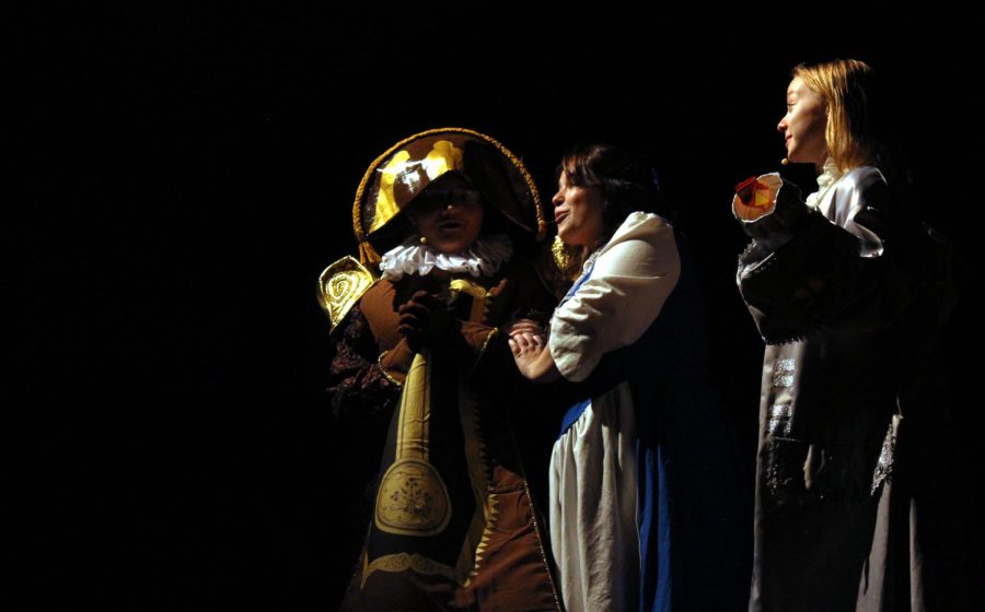 Belle (Carnes) discusses with Lumiere, played by senior Callie Bekker, and Cogsworth, played by senior Cameron Parker, about how she feels about Beast.